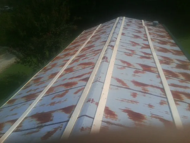 Rusted metal roof panels with new wood purlins before replacement — Storm Damage Roof Repair in Glastonbury by Roofing Brothers