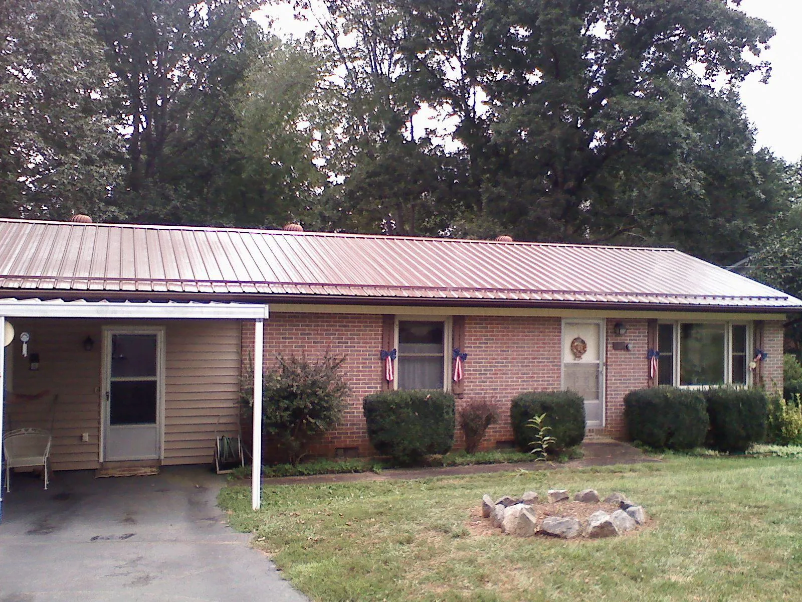 Bronze metal roof and carport on a brick ranch home — Roof Repair work by our crew in Glastonbury